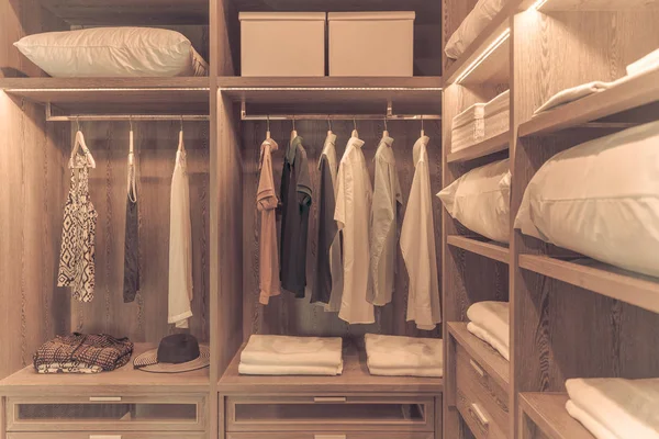 wooden wardrobe in walk in closet