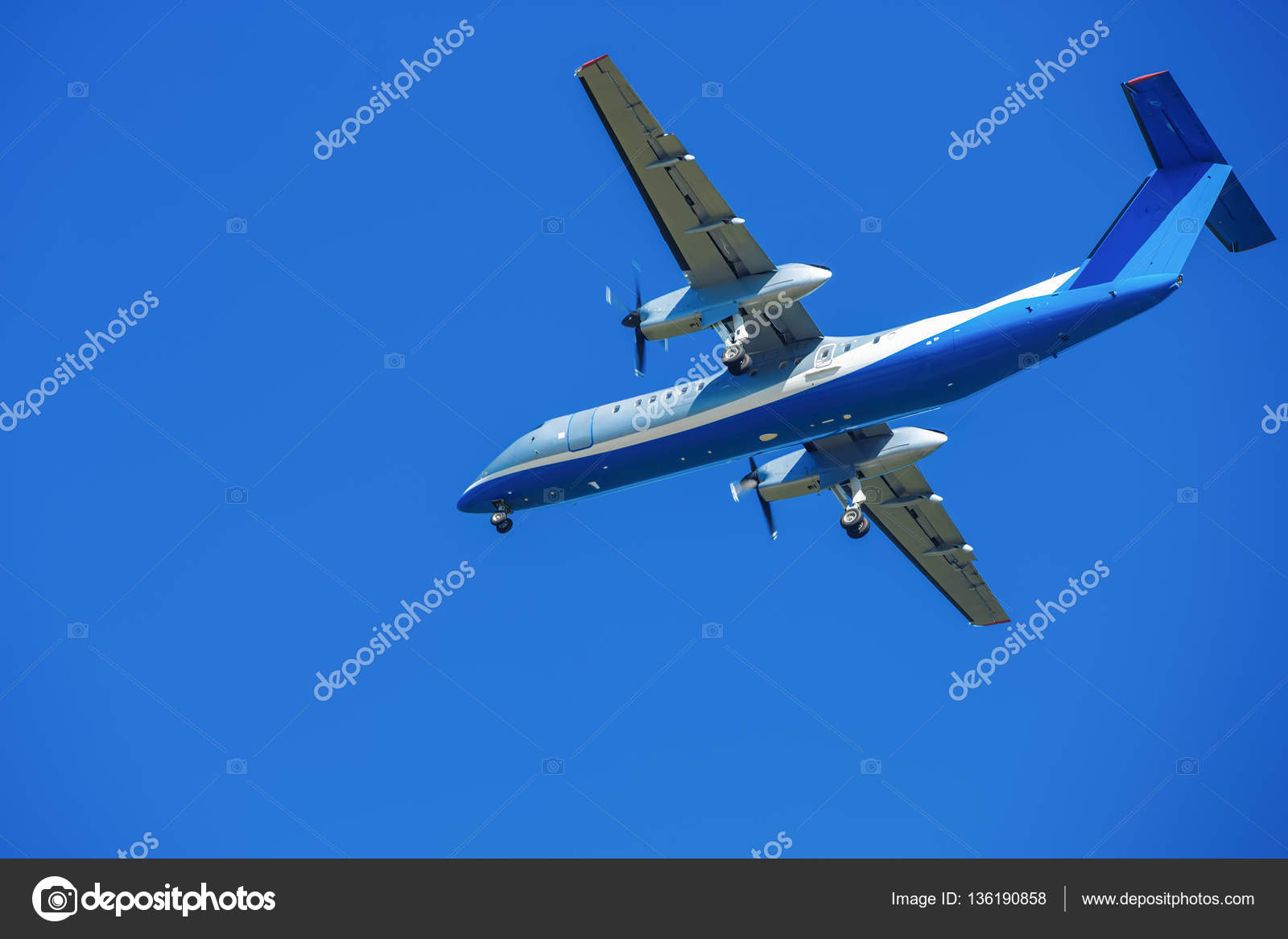 Widebody plane is flying in blue sky Stock Photo by ©ezumer 136190858