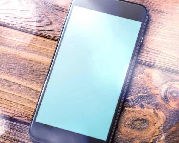 Mockup of smartphone laying on table — Stock Photo, Image