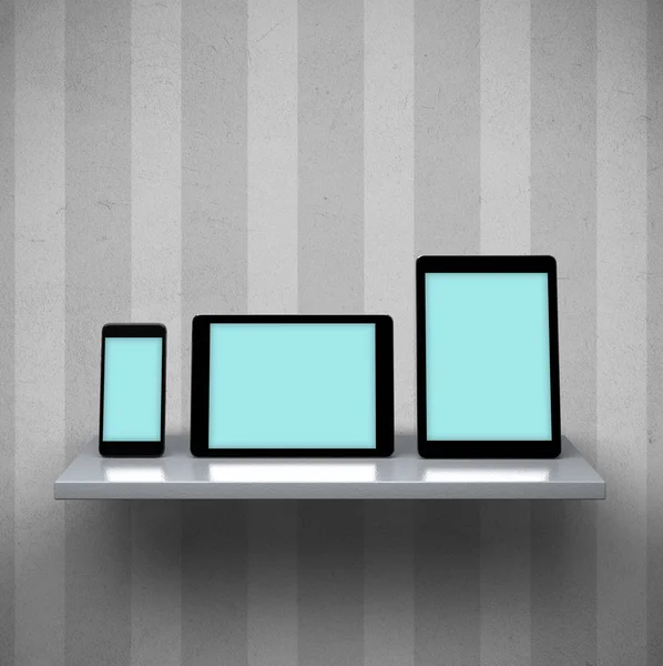 Digital tablet computers and smart phone on a shelf — Stock Photo, Image