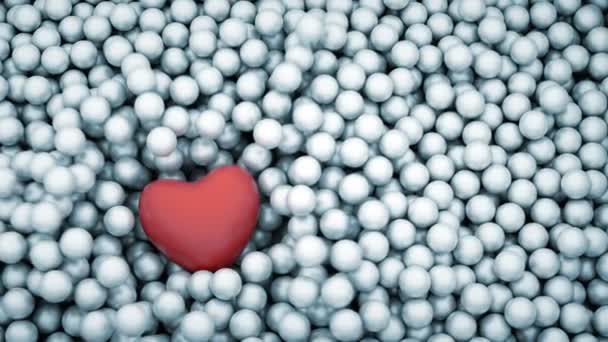 Red heart shape falling into glossy balls — Stock Video