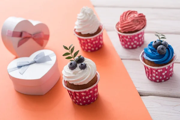 Cupcakes and heart shaped gift boxes — Stock Photo, Image