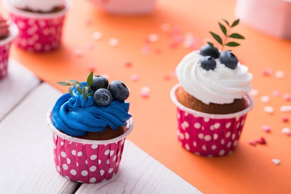 Two delicious cupcakes on a table — Stock Photo, Image