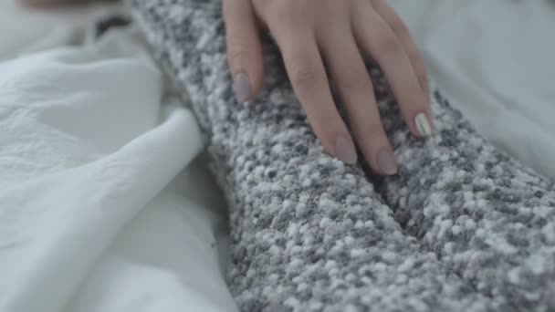 Woman in warm socks leads her hand along her leg. Close up — 비디오