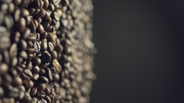Closeup of coffee beans fall down in slow motion — Stockvideo