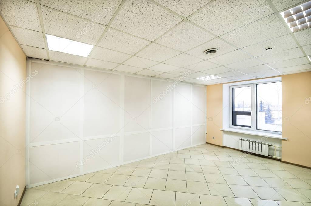 Empty office space with large windows