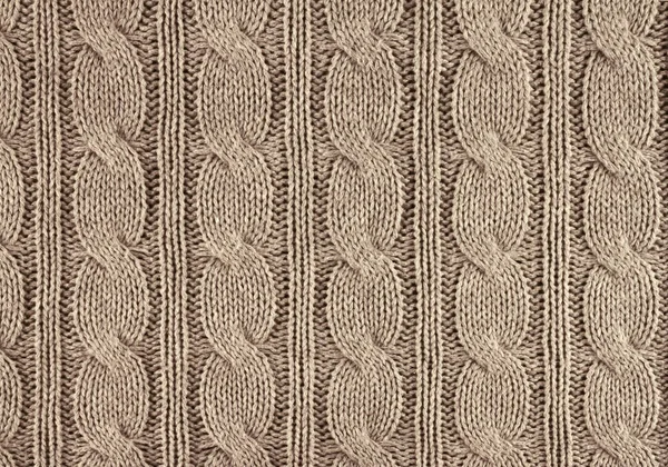 beige knitted textured background with a pattern closeup