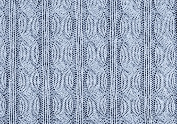 blue knitted textured background with a pattern closeup