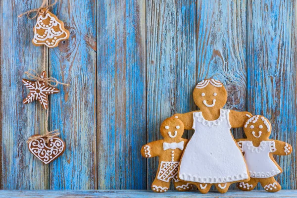 Gingerbread, gingerbread men on blue wooden background, Christmas or New Year background, template greeting card