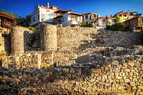 City landscape - Old fortress wall on the background of the city houses