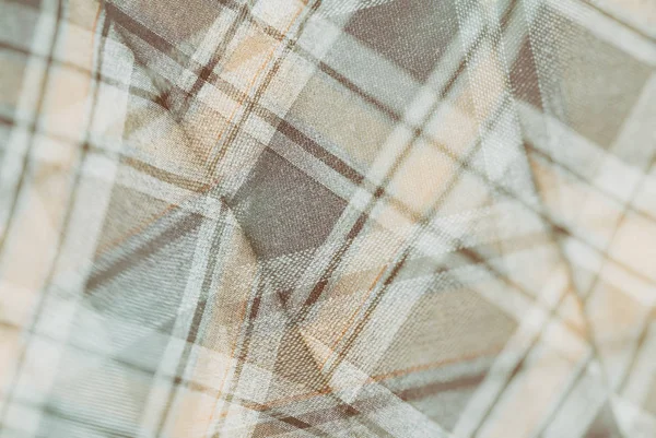 Flannel, cotton into the classic scottish cell as textile background in vintage style,  double exposure photo