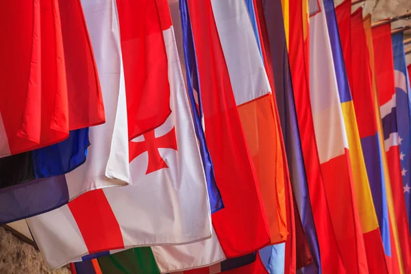 City landscape - view of the hanging flags of different countries closeup near the Hofburg Palace in the city of Vienna, Austria