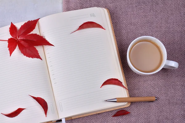 Autumn composition with cup of coffee, autumn leaves and and opened book open book with blank pages. Top view, flat lay, copy space — Stock Photo, Image