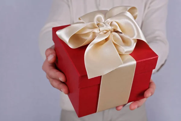 Man holding red present with white Ribbon close up . Gift box. Birthday, New year, Valentine's Day, 8 march, Christmas concept. — Stock Photo, Image