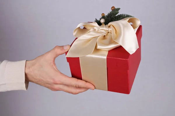 Man holding red present with white Ribbon close up on hand. Gift box. , New year, Christmas concept. — Stock Photo, Image