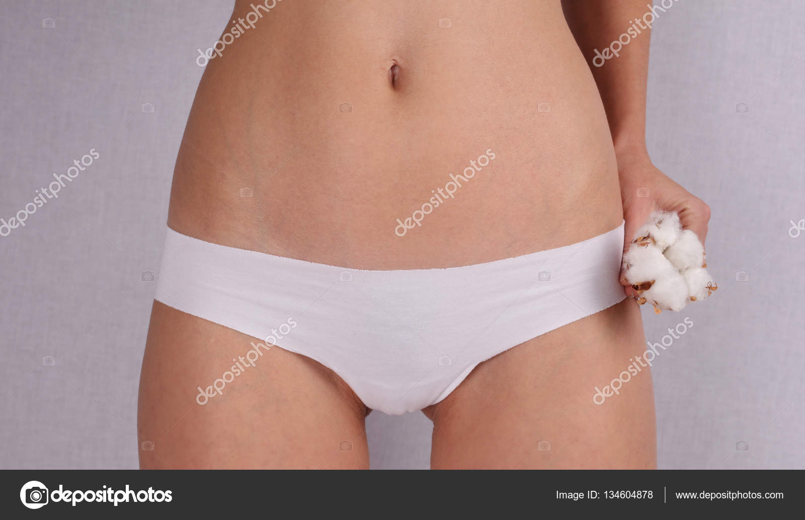 Woman wearing cotton panties and holding cotton flower close up. Female  underwear made from natural organic materials Stock Photo by ©glisic_albina  134604878