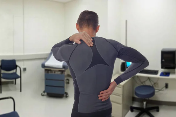 Chiropractic, osteopathy, Physiotherapy, sport injury rehabilitation. Alternative medicine, pain relief concept. Man patient suffering from back pain during medical exam.