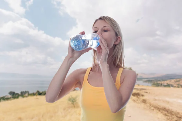 Sport fitness woman dinrinking water outdoors. Jogging, sport, Fitness, Active lifestyle concept