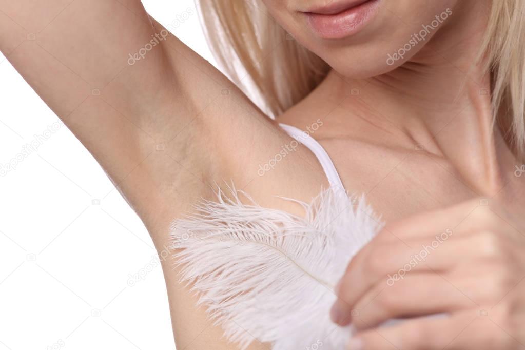Armpit epilation, laser hair removal. Young woman holding her arms up and showing underarms, smooth clean skin
