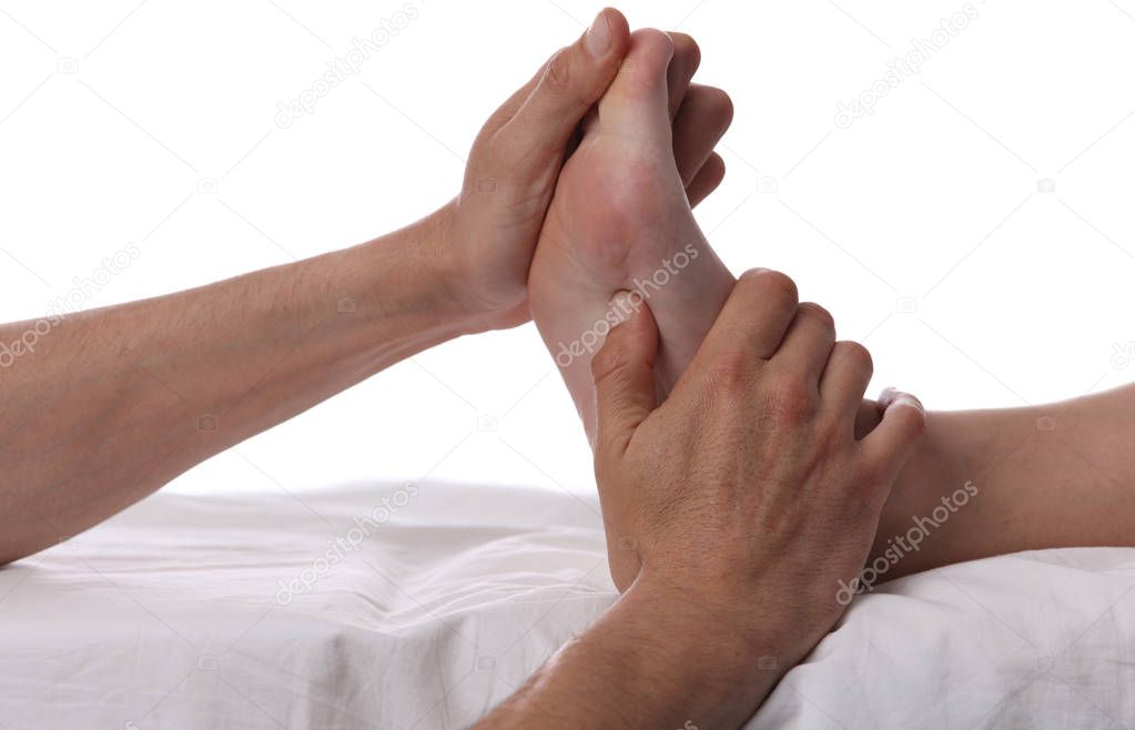 Woman enjoying foot massage. Soft gentle skin. Acupressure. Therapist doing healing treatment treatment on female feel . Alternative medicine, pain relief concept