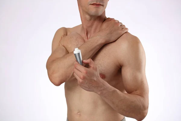 Hombre aplicando crema analgésica, gel. Lesión deportiva, hombre con espalda, dolor de cuello. Alivio del dolor y concepto de atención médica . — Foto de Stock