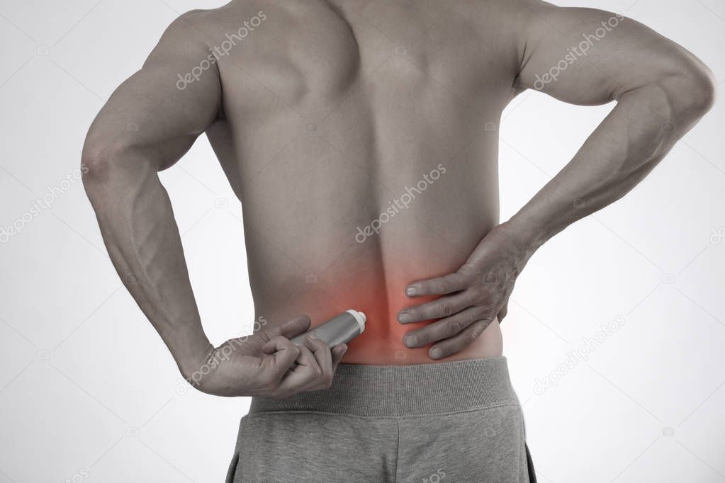 Man applying pain relieving cream, gel. Sport injury, Man with b