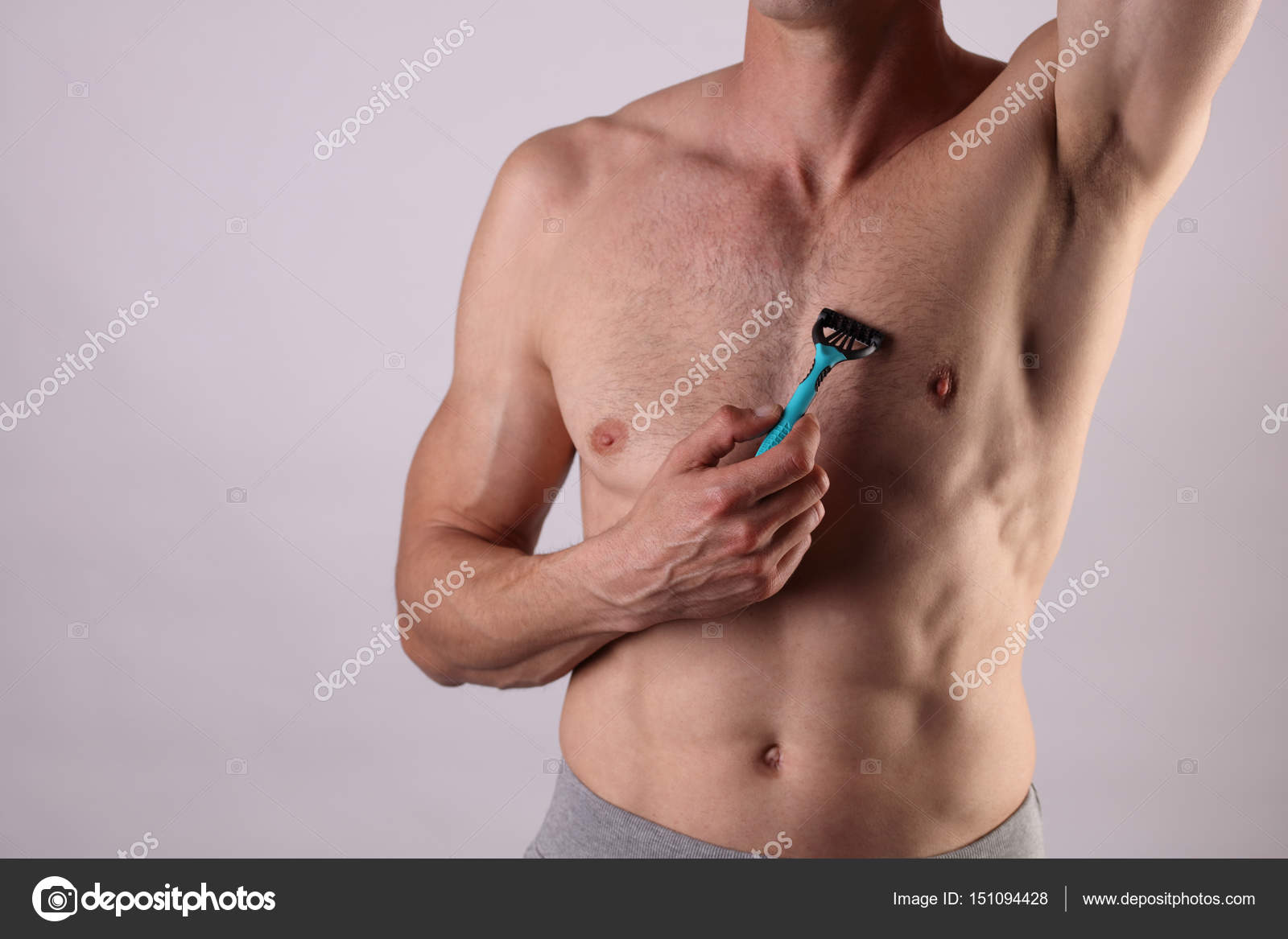 Muscular male torso close up , chest and armpit , underarm hair removal.  Male depilation. Young attractive muscular man using razor to remove hair  from his body Stock Photo by ©glisic_albina 151094428