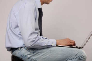 Man bad poor sitting posture. Business man using laptop computer clipart