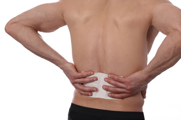 Medicated pain relief patch, plaster. man with back pain. Pain relief and health care concept isolated on white. — Stock Photo, Image