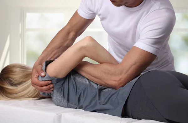 Chiropractic arka ayarlama sahip bir kadın. Osteopati, Acupressure, alternatif tıp, ağrı Rölyef kavramı. Fizyoterapi, spor yaralanma rehabilitasyon