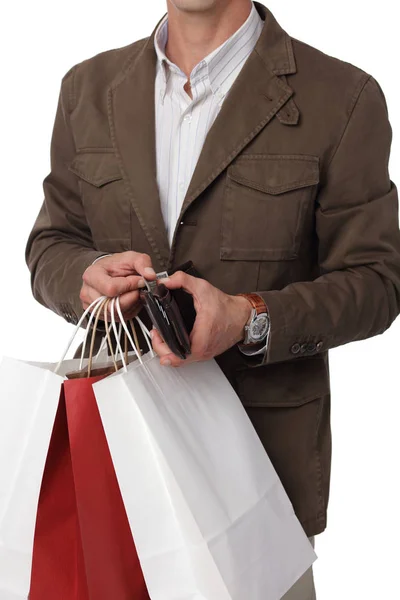 Człowiek, zakupy. Mężczyzna posiadający torby na zakupy i portfel na białym tle. — Zdjęcie stockowe