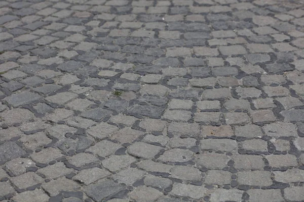 Vecchio usato strada basalto pietra pavimentazione sfondo . — Foto Stock