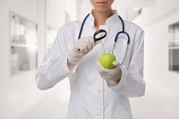 Food science, GMO food concept . Scientist inspecting apple sample at laboratory