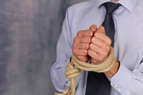 Businessman bound hands, hands tied in ropes. Problems, restrictions and limits in work. — Stock Photo, Image