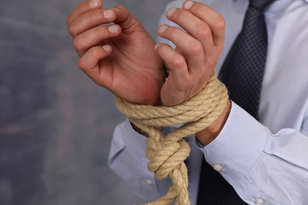 Businessman with a rope tied hands. Rules, law prevents, restrictions and limits in work. — Stock Photo, Image