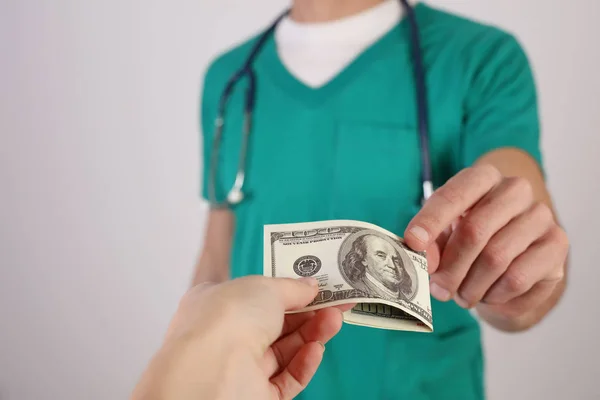 Corruption and bribery in Healthcare and medicine. Doctor taking money. Health insurance — Stock Photo, Image