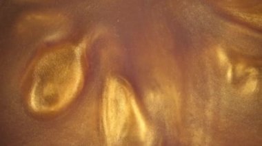 4 k görüntüleri. Suda mürekkep. Altın mürekkep arka plan oluşturma suya tepki.