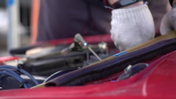 Zeitlupentempo. Ein Mann repariert ein Auto. Hände aus nächster Nähe — Stockvideo