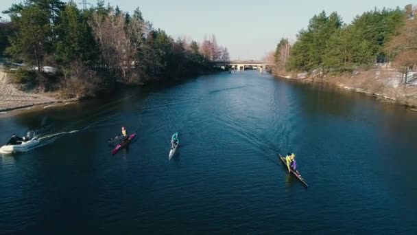 Aerial footage. Front view. Following three kayaks on river at spring slow motion — Stock Video