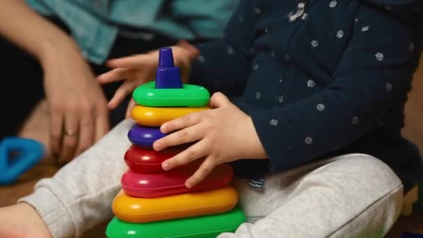 Child plays with designer kit on the floor, top view — Stock Video