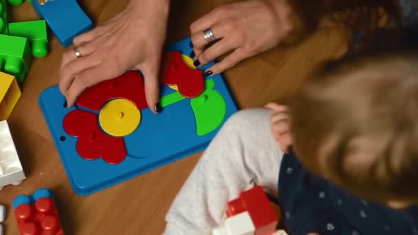 Το παιδί παίζει με το κιτ σχεδιαστών στο πάτωμα, κορυφαία άποψη — Αρχείο Βίντεο