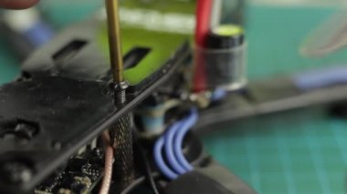 Tornavida kullanarak FPV yarış aracı monte eden genç adamların aşırı yakınlaşması..
