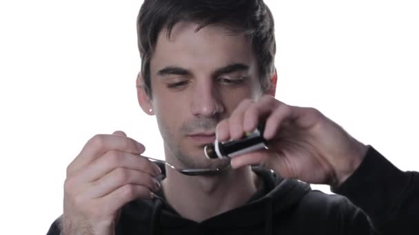 Portrait of a young man makes dripping drops of medicine into a spoon removes the mask and drinks isolate — Stock Video