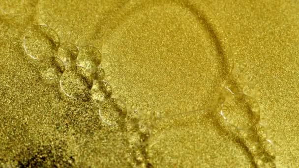 Gold Ink Částice abstraktní pozadí s olejovými bublinami, close-up — Stock video