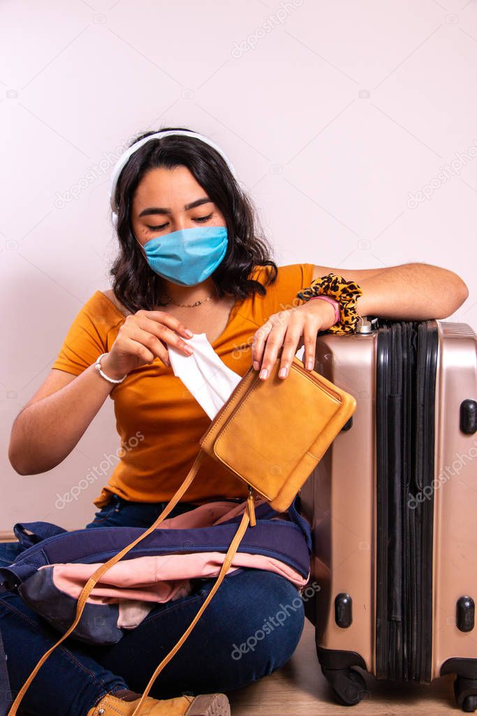 masked lady pulling out a tissue