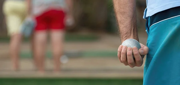 Petanque ball in hand of man — Stock Photo, Image