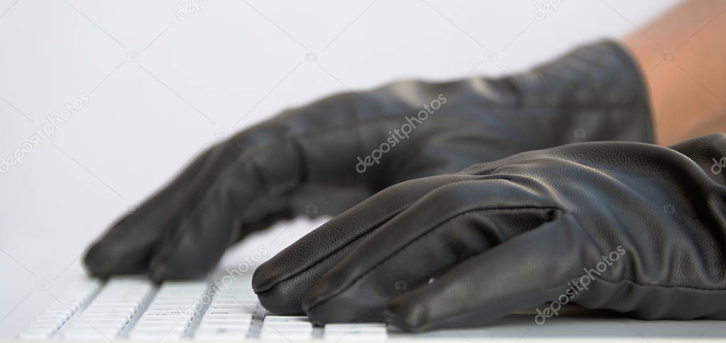 Hacker in black gloves