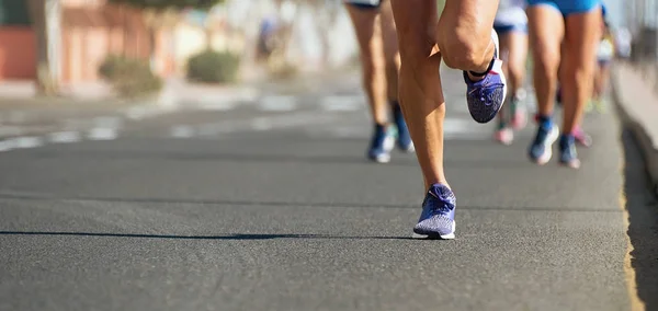 Marathon running in the light of evening,running on city road detail on legs