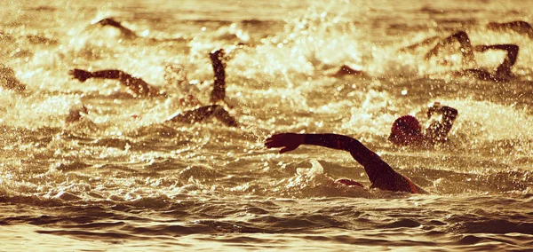 The swimmer\'s silhouette during the early racing in swimming