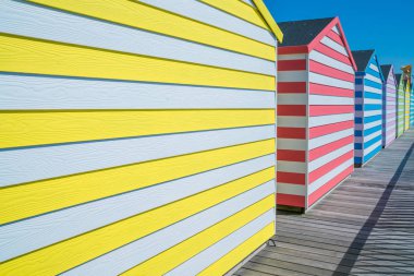 Colorful wooden huts on Hastings pier clipart